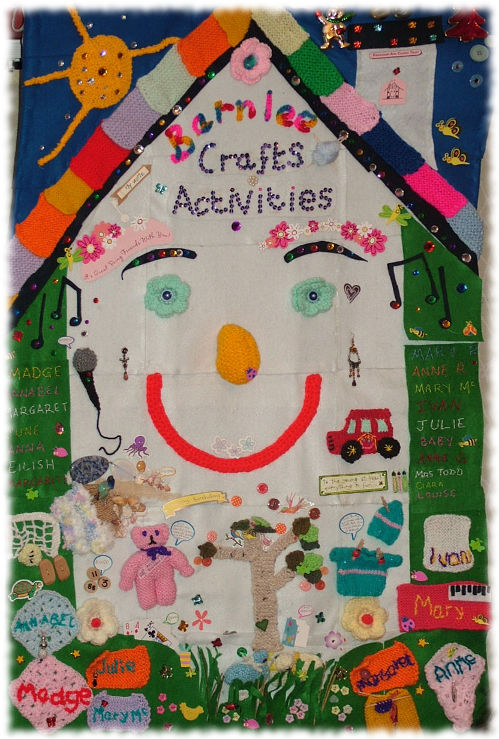 Wallhanging depicting FACT house logo and life and activities at Barnlee